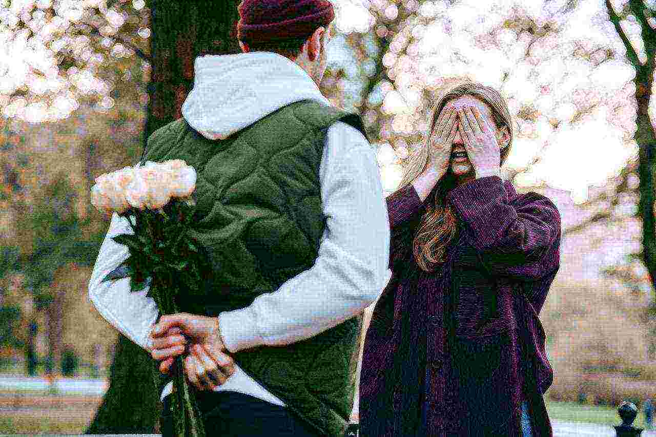 man giving girl friend flowers