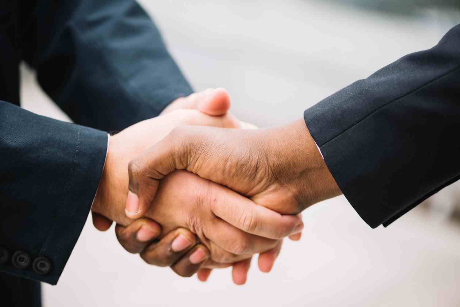 What the two-handed handshake means